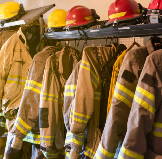 Firefighters uniforms and gear arranged in fire station
